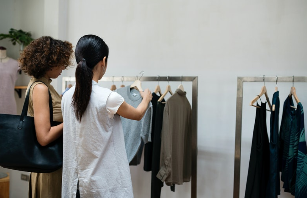 two women choose clothes in shop